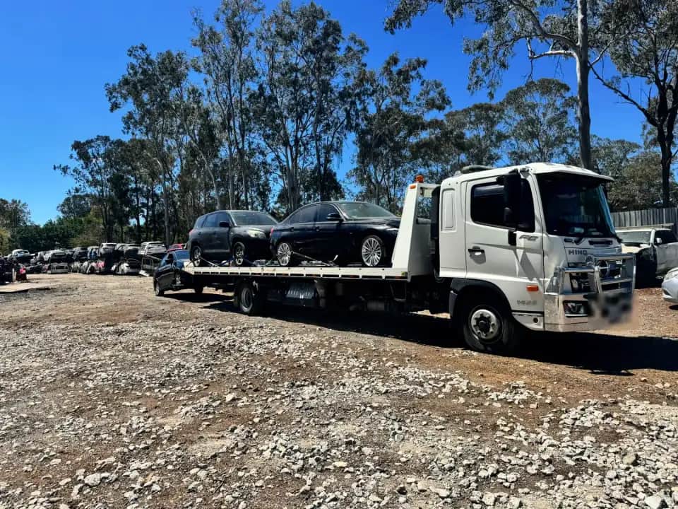 The A1 tow truck back at the Willawong yard with two cars on the deck