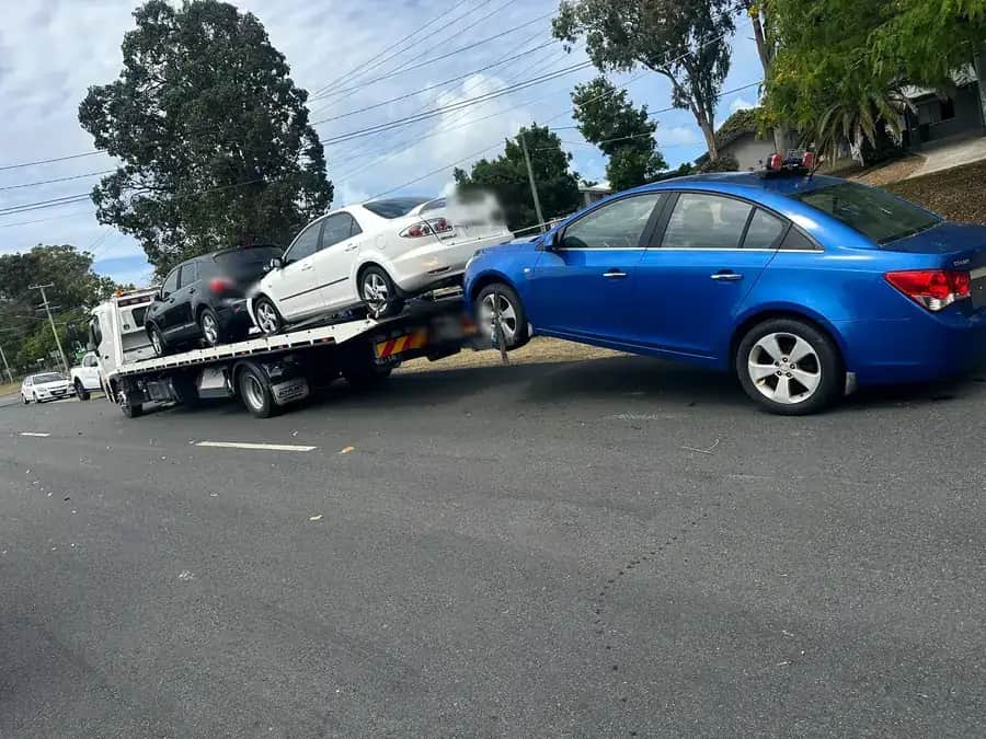 Rear view of the A1 tow truck towing a blue sedan away