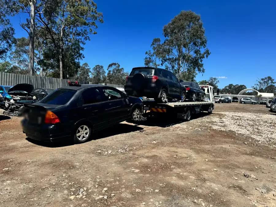 The A1 tow truck arriving at the yard with a towed sedan